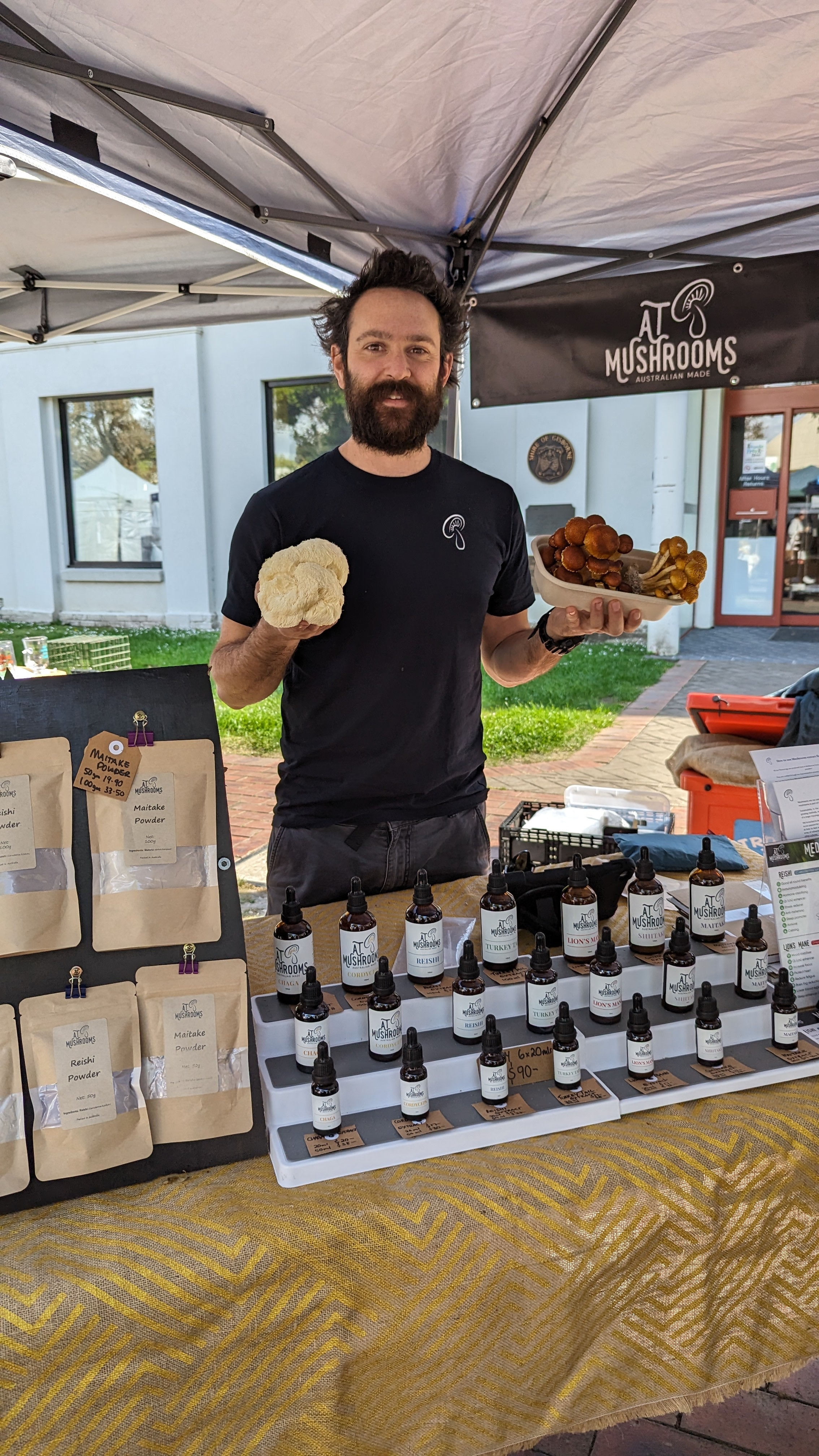 Terry Holding fresh Lions Mane and chestnut mushrooms at markets